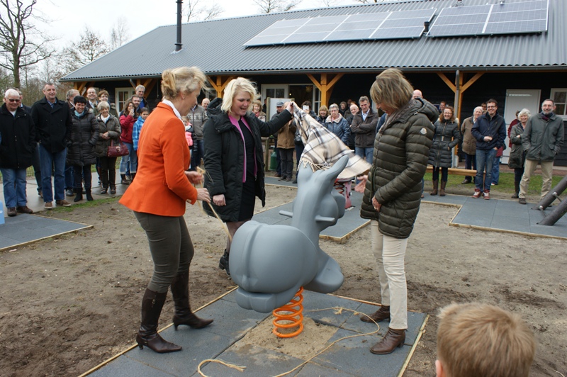 De ezels zijn er even niet maar in de speeltuin is een wipezel. Wethouder Nieuwenhuizen onthulde ezel en opende officieel de kinderboerderij. Eigenaresse Sandy Seijn (m) heeft volop plannen. 